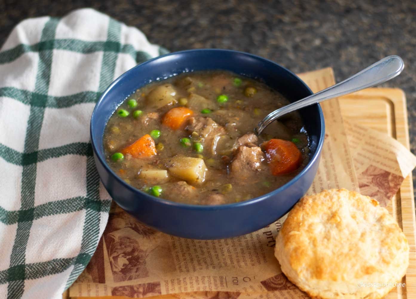 beef stew with biscuit on tray